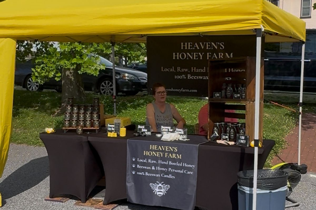 Local vendor at a Southern York County summer farmers market selling honey and beeswax products