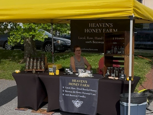 Local vendor at a Southern York County summer farmers market selling honey and beeswax products